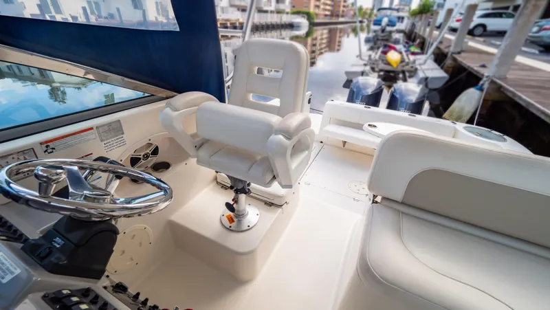Slide: The Image of 2010 Robalo R305 Walkaround boat interior with steering wheel and seating. - 3