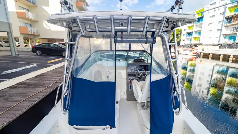 Slide: The Image of 2010 Robalo R305 Walkaround boat docked near waterfront buildings. - 30