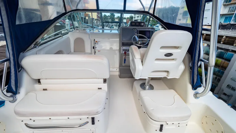 Slide: The Image of 2010 Robalo R305 Walkaround boat interior with white seating and steering console. - 31