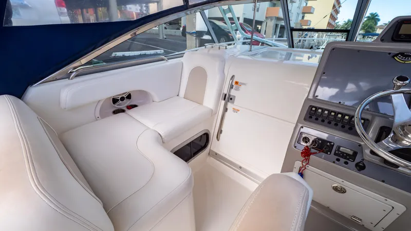 Slide: The Image of 2010 Robalo R305 Walkaround boat interior with white seating and control panel. - 33