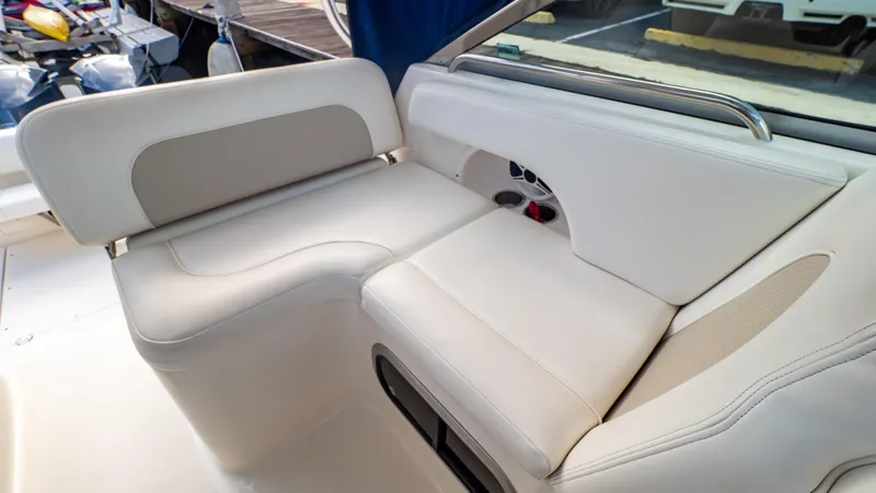 Slide: The Image of 2010 Robalo R305 Walkaround boat interior with white cushioned seating. - 34