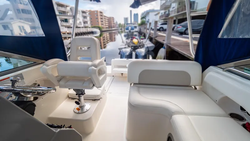 Slide: The Image of Interior view of 2010 Robalo R305 Walkaround boat docked in a marina. - 35