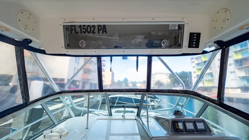 Slide: The Image of Interior view of 2010 Robalo R305 Walkaround boat cockpit with clear windows. - 36
