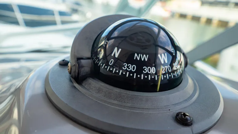 Slide: The Image of Compass on 2010 Robalo R305 Walkaround boat, showing northwest direction. - 39