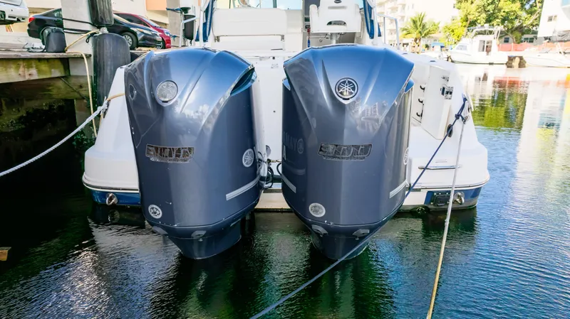 Slide: The Image of 2010 Robalo R305 Walkaround with twin outboard engines docked in marina. - 4
