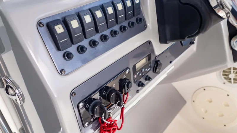 Slide: The Image of Control panel of 2010 Robalo R305 Walkaround boat with switches and gauges. - 43