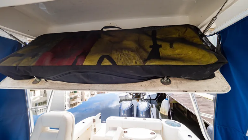 Slide: The Image of 2010 Robalo R305 Walkaround boat interior with storage compartment and seating. - 44