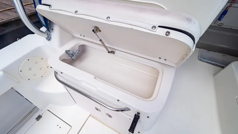 Slide: The Image of Open storage compartment on 2010 Robalo R305 Walkaround boat. - 48
