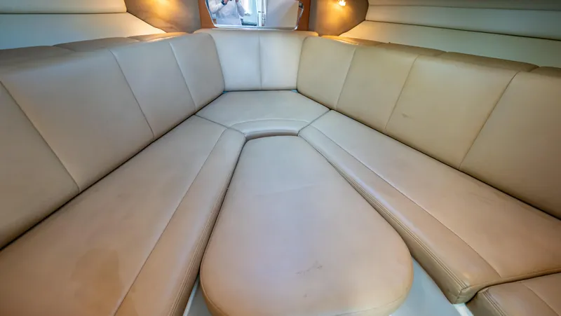 Slide: The Image of 2010 Robalo R305 Walkaround cabin interior with beige seating. - 7