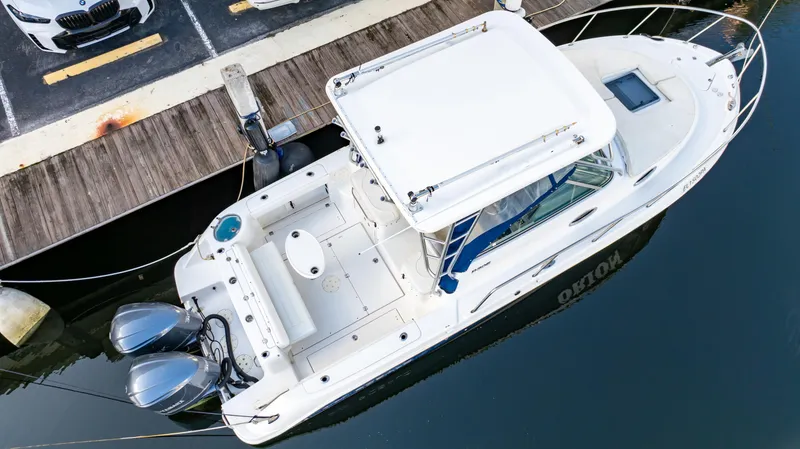 Slide: The Image of 2010 Robalo R305 Walkaround boat docked with twin engines. - 8