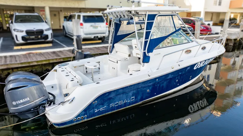Slide: The Image of 2010 Robalo R305 Walkaround boat docked with Yamaha engine. - 9