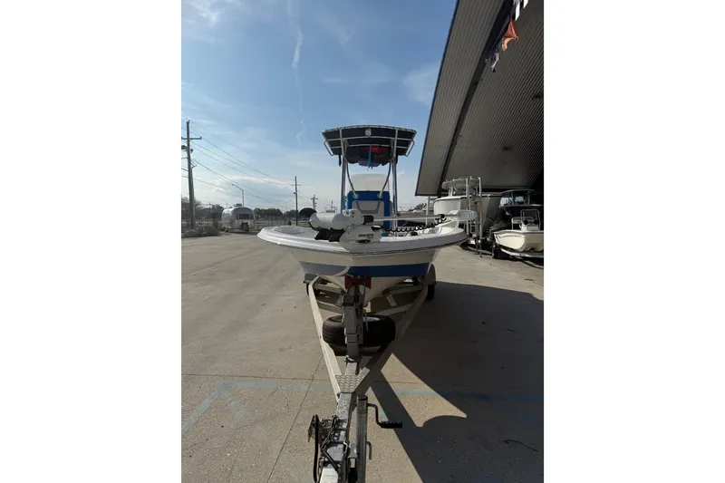 Slide: The Image of 2020 Aquasport 224 Bay boat on trailer, parked outdoors under clear sky. - 7