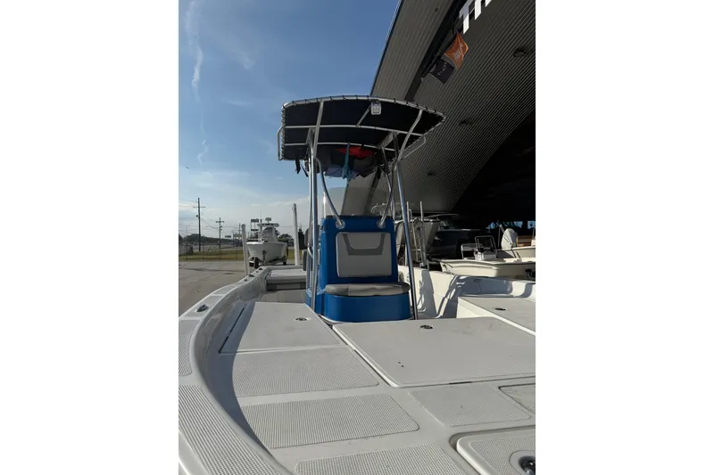 Slide: The Image of 2020 Aquasport 224 Bay boat with T-top, docked under a canopy. - 8
