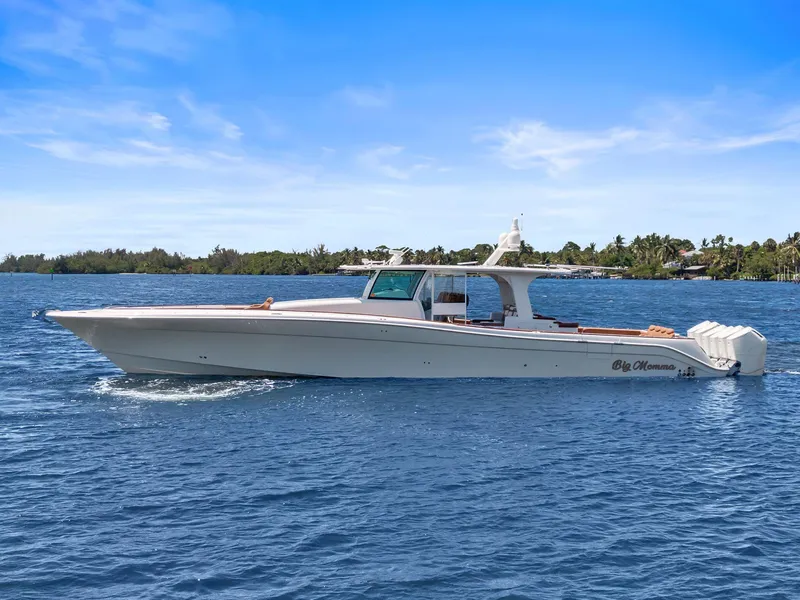 The Image of 2023 HCB 65 Estrella luxury boat cruising on blue water under clear sky. - 0