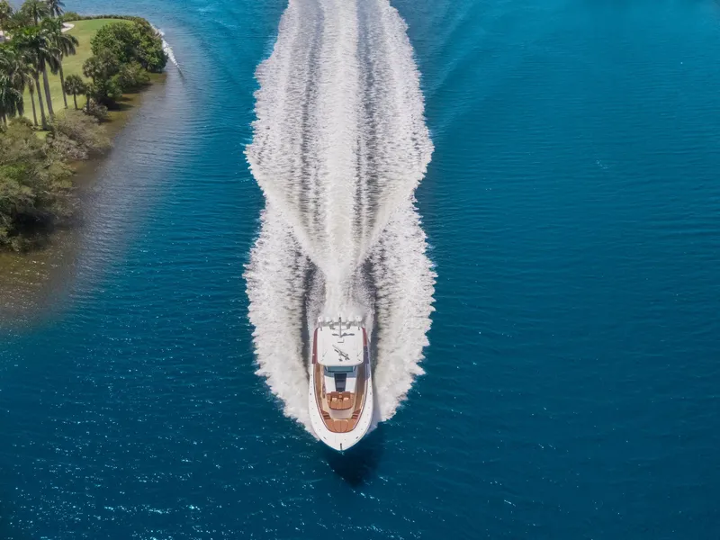 Slide: The Image of Aerial view of 2023 HCB 65 Estrella yacht cruising on blue water. - 12