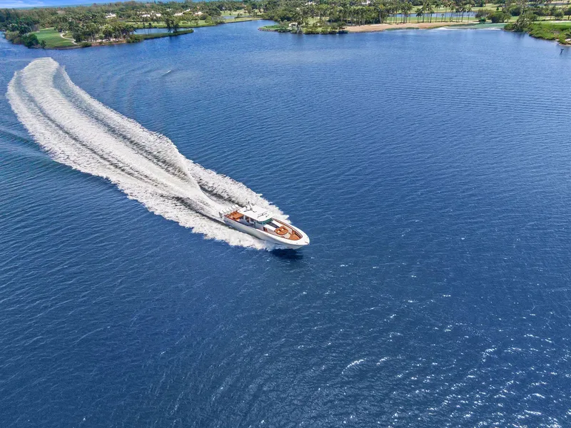 Slide: The Image of Aerial view of 2023 HCB 65 Estrella yacht cruising on a vast blue lake. - 13