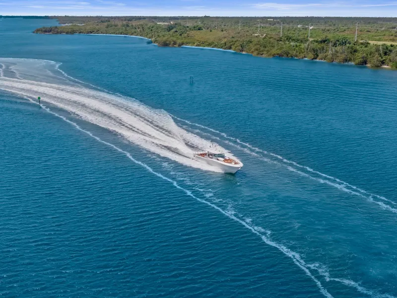 Slide: The Image of 2023 HCB 65 Estrella cruising on a scenic blue waterway. - 14