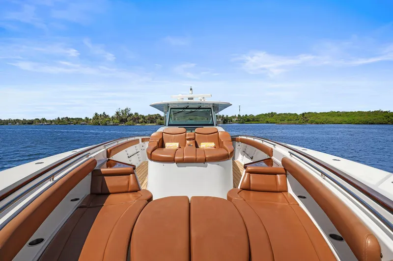 Slide: The Image of 2023 HCB 65 Estrella luxury yacht with brown leather seating on open water. - 17