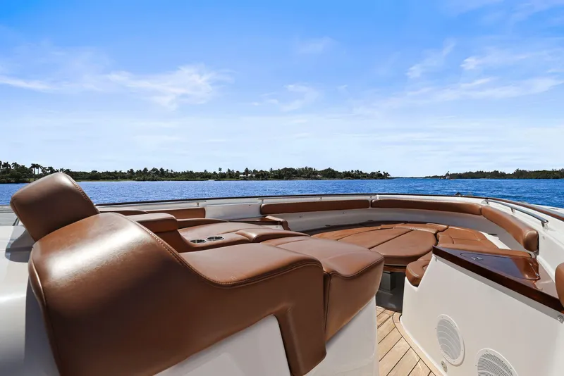 Slide: The Image of Luxurious seating on 2023 HCB 65 Estrella yacht, overlooking serene blue waters and clear sky. - 18