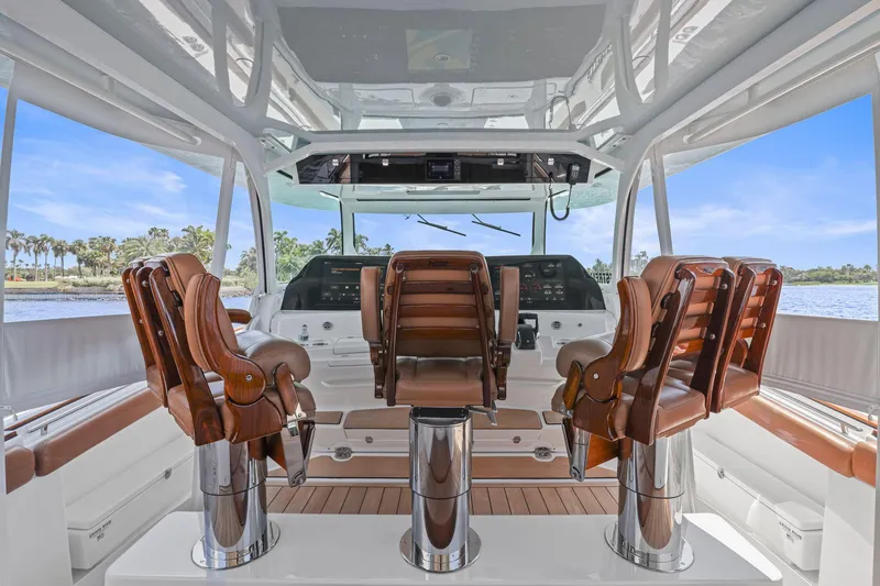 Slide: The Image of 2023 HCB 65 Estrella yacht interior with luxurious leather seating and advanced navigation controls. - 25