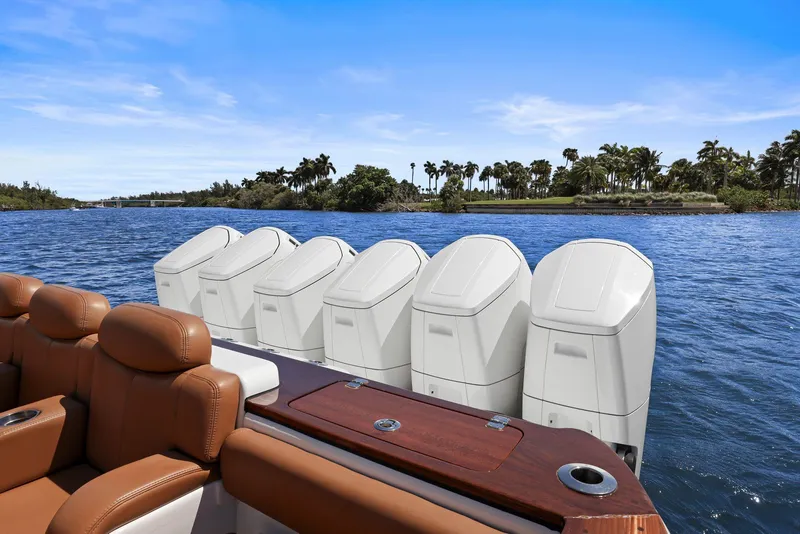 Slide: The Image of 2023 HCB 65 Estrella boat with six powerful outboard engines on a sunny day. - 37