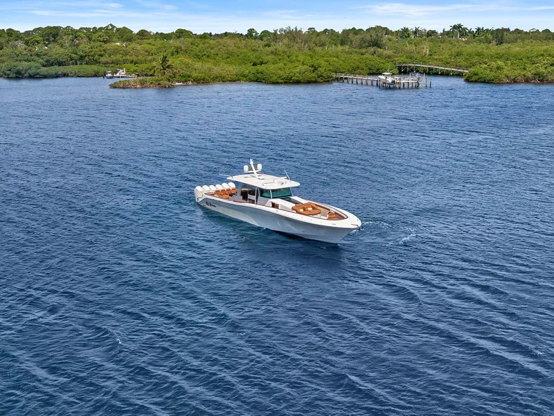 Slide: The Image of 2023 HCB 65 Estrella luxury yacht cruising on a serene blue lake near lush green shoreline. - 4