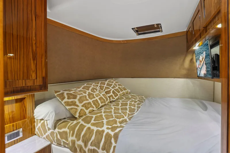 Slide: The Image of Luxurious cabin interior of 2023 HCB 65 Estrella yacht with cozy bedding and wood accents. - 50