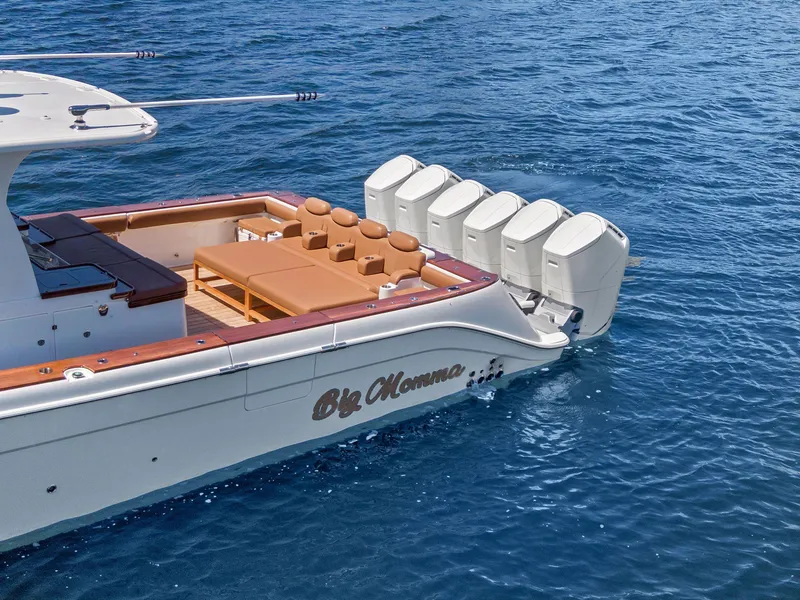 Slide: The Image of 2023 HCB 65 Estrella luxury boat with multiple engines on blue water. - 6