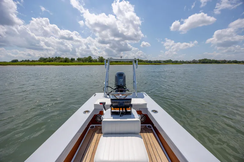 Slide: The Image of Custom Carolina 18 Flats boat on calm water, clear sky, 2023 model. - 19
