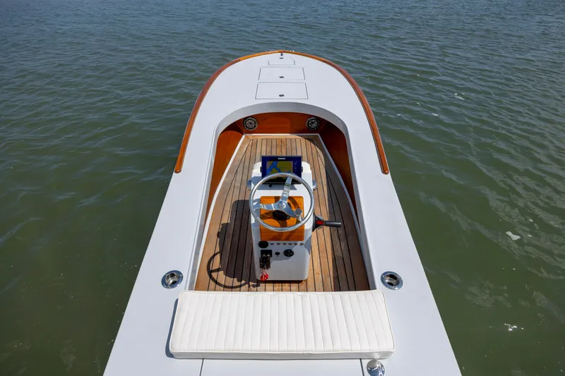 Slide: The Image of 2023 Custom Carolina 18 Flats boat with sleek design on calm water. - 21