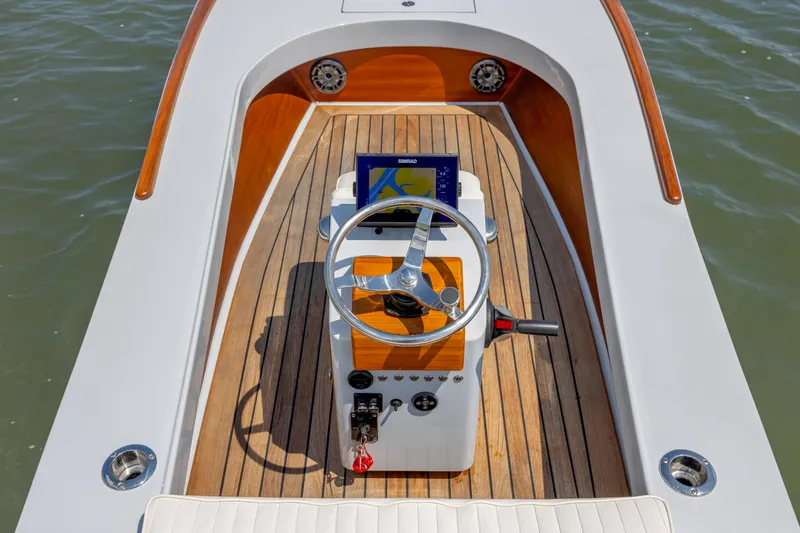 Slide: The Image of 2023 Custom Carolina 18 Flats boat interior with steering wheel and navigation system. - 22