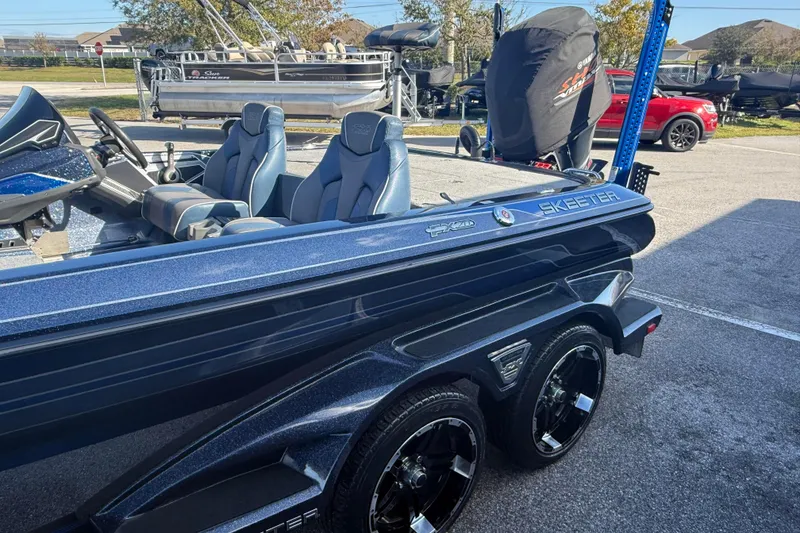Slide: The Image of 2018 Skeeter FX20 boat with sleek design and modern seating in a parking lot. - 2