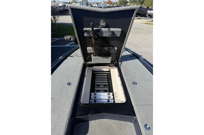 Slide: The Image of 2018 Skeeter FX20 boat storage compartment open, revealing organized interior. - 7