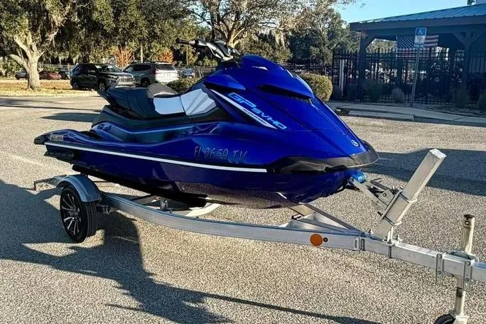 Slide: The Image of 2024 Yamaha WaveRunner GP SVHO in blue on a trailer, parked outdoors. - 3