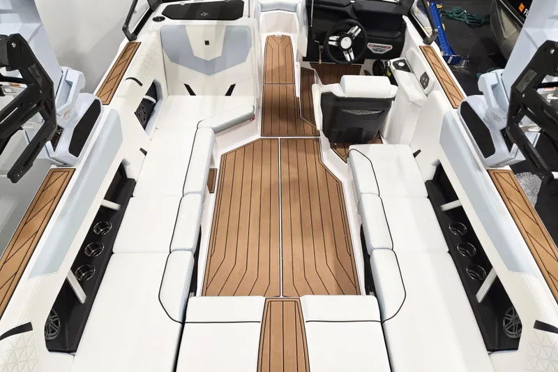 Slide: The Image of 2026 Nautique Super Air Nautique GS22 interior with white seating and teak flooring. - 8