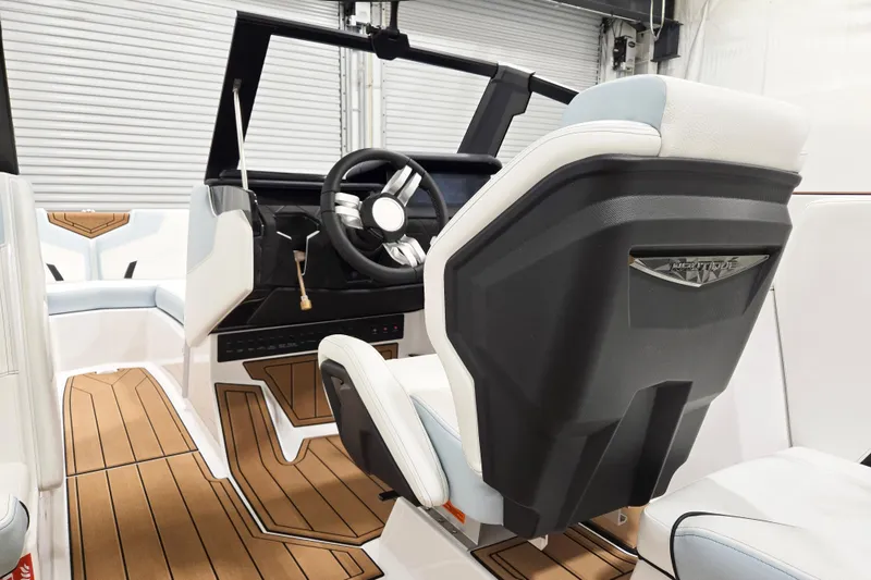 Slide: The Image of 2026 Nautique Super Air Nautique GS22 interior with sleek design and modern steering wheel. - 9
