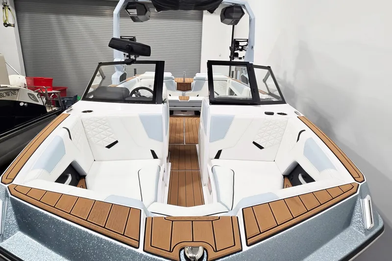 Slide: The Image of 2026 Nautique Super Air Nautique GS22 boat interior with white seating and wood accents. - 3