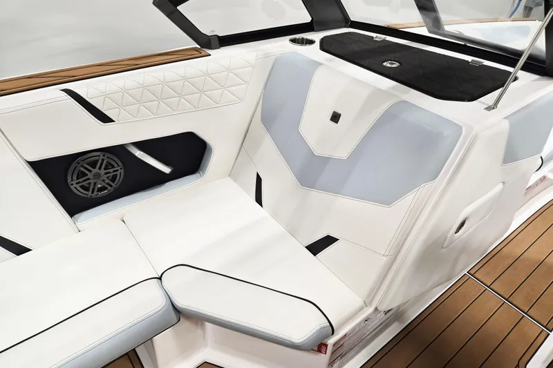 Slide: The Image of 2026 Nautique Super Air Nautique GS22 interior with white and blue seating, speaker, and teak flooring. - 10