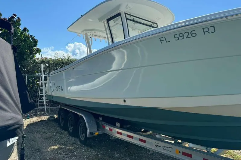 Slide: The Image of 2017 Robalo R302 Center Console boat on trailer, side view. - 5