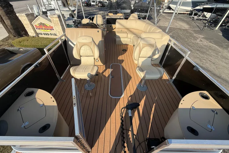 Slide: The Image of 2020 Lund LX220 Pontoon Fish boat with beige seating and wood-style deck. - 5