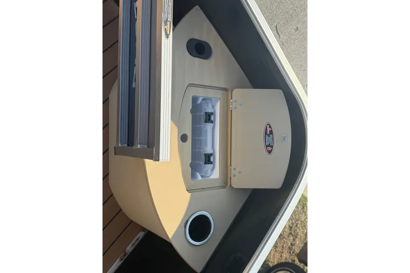 Slide: The Image of 2020 Lund LX220 Pontoon Fish boat interior with storage compartment and cup holder. - 6