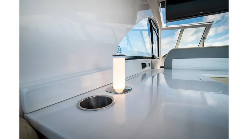 Slide: The Image of 2022 Regal LS36 yacht interior with sleek white countertop and modern lighting. - 11