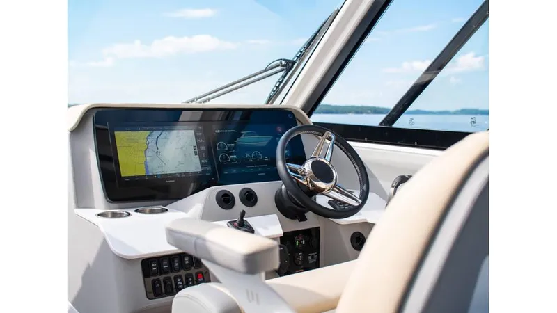 Slide: The Image of 2022 Regal LS36 boat helm with modern navigation display and steering wheel. - 2