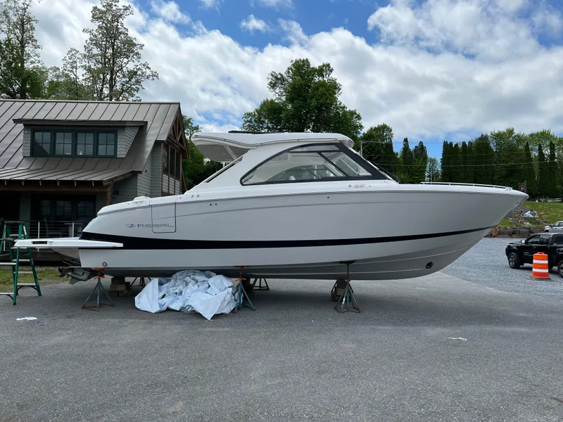 Slide: The Image of 2022 Regal LS36 boat on display outdoors near a modern building. - 20
