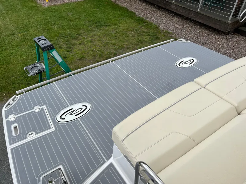 Slide: The Image of 2022 Regal LS36 boat deck with beige seating and gray flooring. - 26