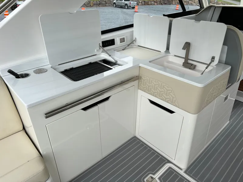 Slide: The Image of 2022 Regal LS36 boat kitchen area with sink and grill. - 32