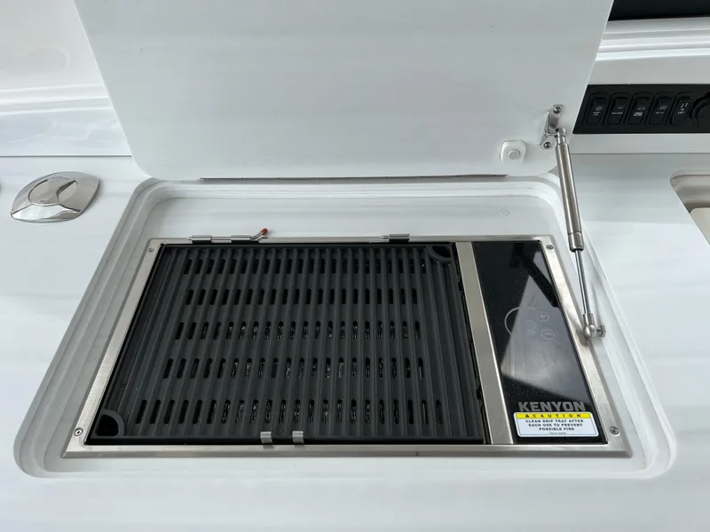 Slide: The Image of Kenyon grill on 2022 Regal LS36 boat, open lid view. - 33