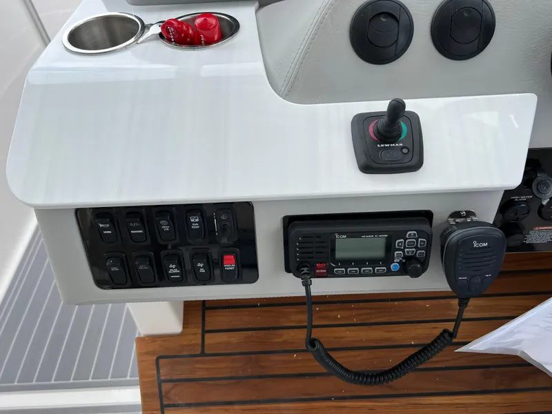 Slide: The Image of Control panel of 2022 Regal LS36 boat with radio and switches. - 42