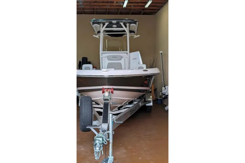 Slide: The Image of 2021 Caymas 26 HB boat on trailer in garage setting. - 14