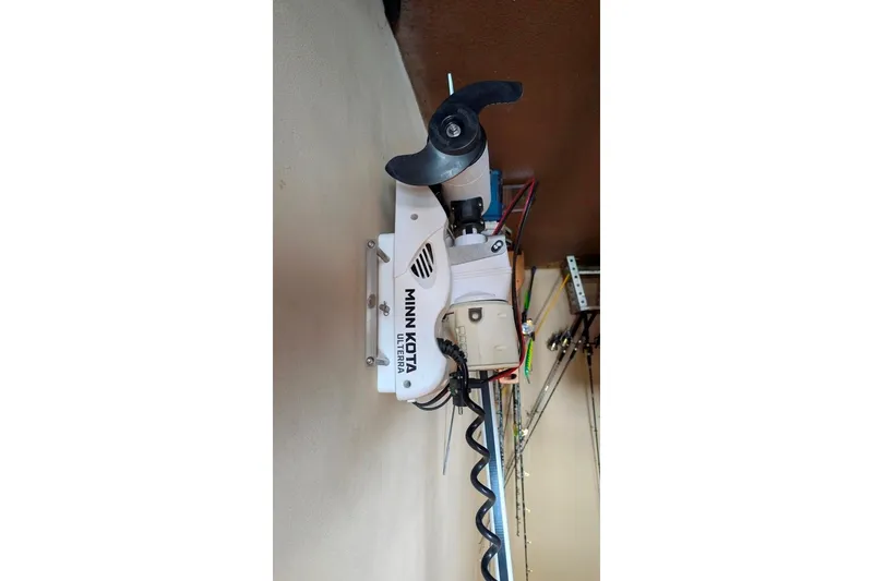 Slide: The Image of Minn Kota Ulterra trolling motor mounted on a 2021 Caymas 26 HB boat. - 15